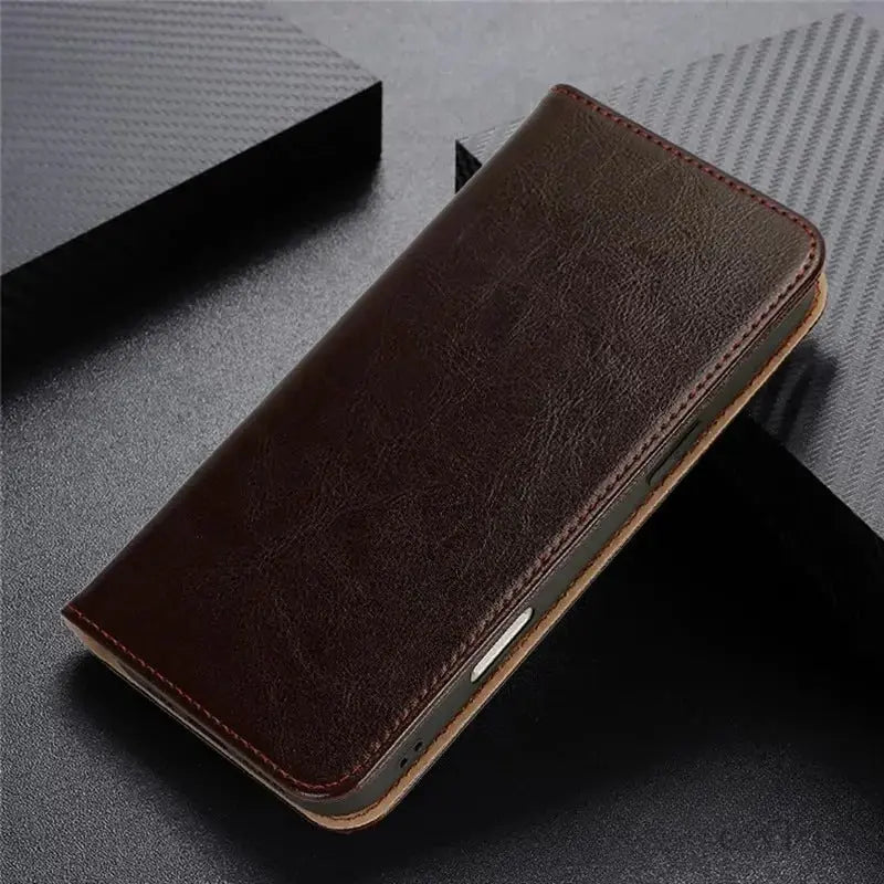 Genova cowhide leather flip case in Mocha Brown, closed, on dark leather