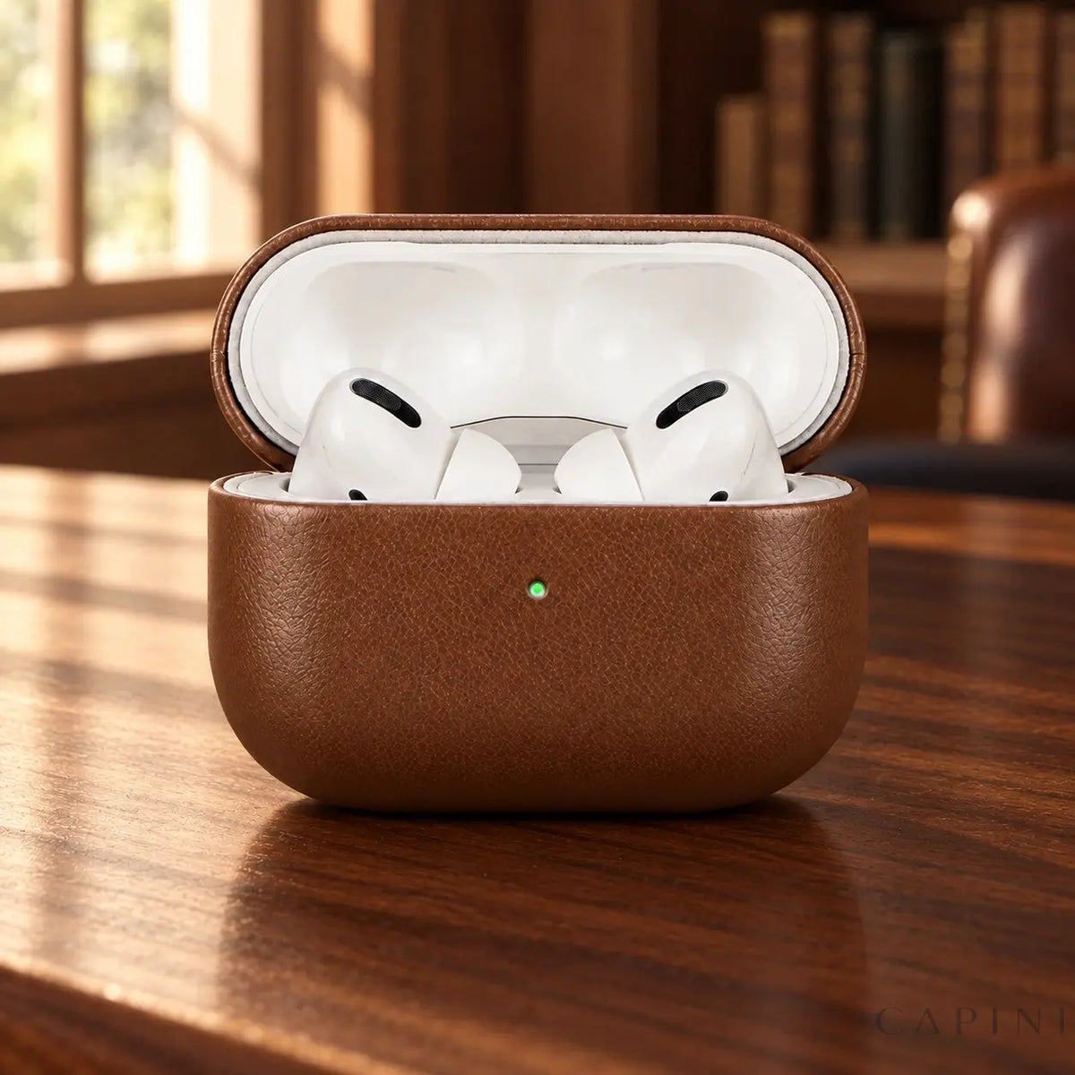 Biella leather case open with AirPods on walnut desk