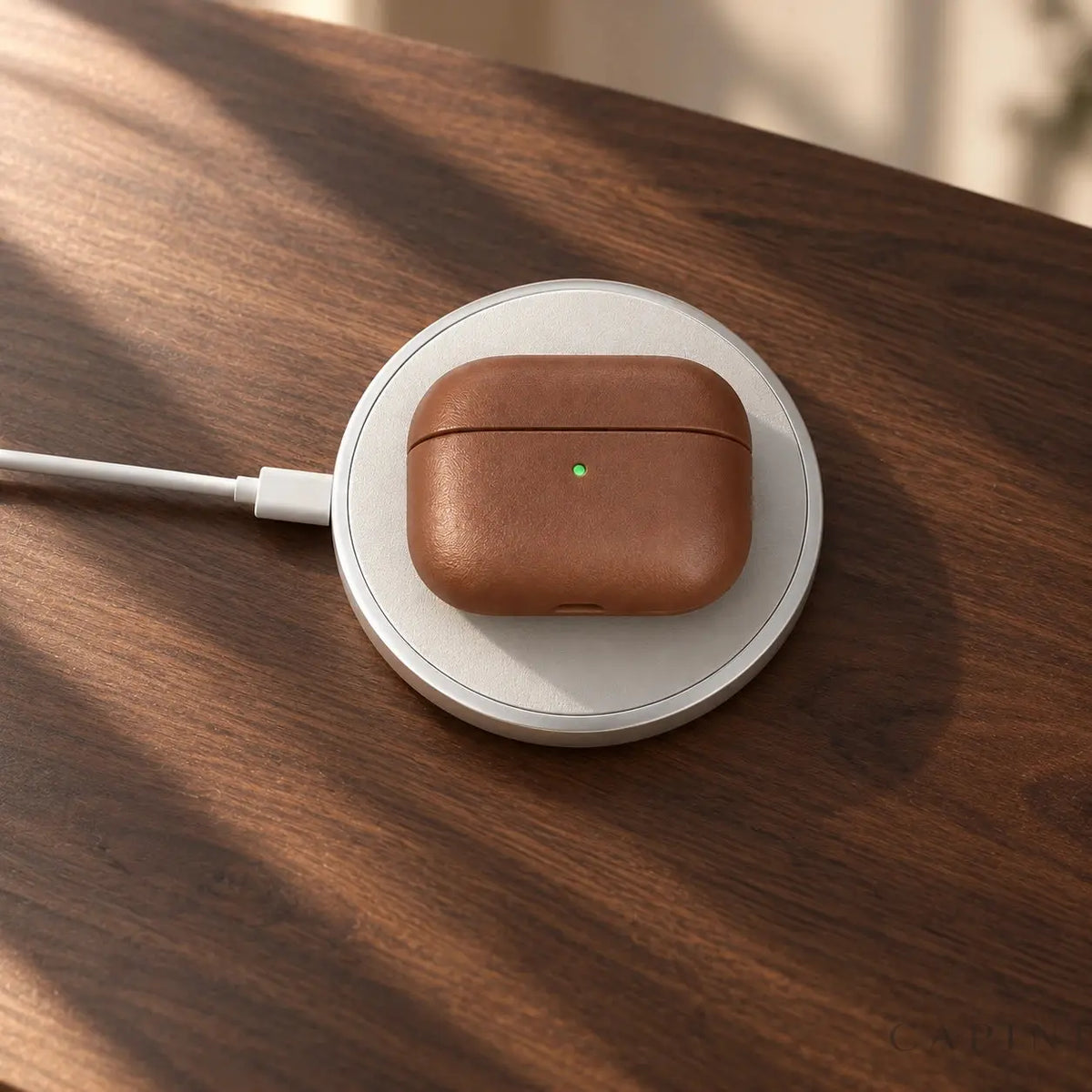 Biella leather case resting on wireless charger on walnut desk