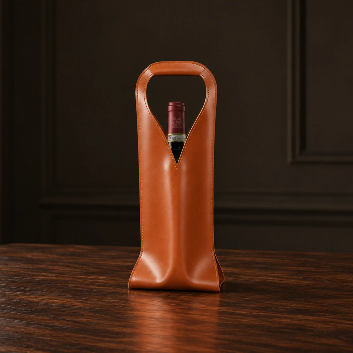 Cormons Loop Handle wine carrier in Cognac on dark walnut