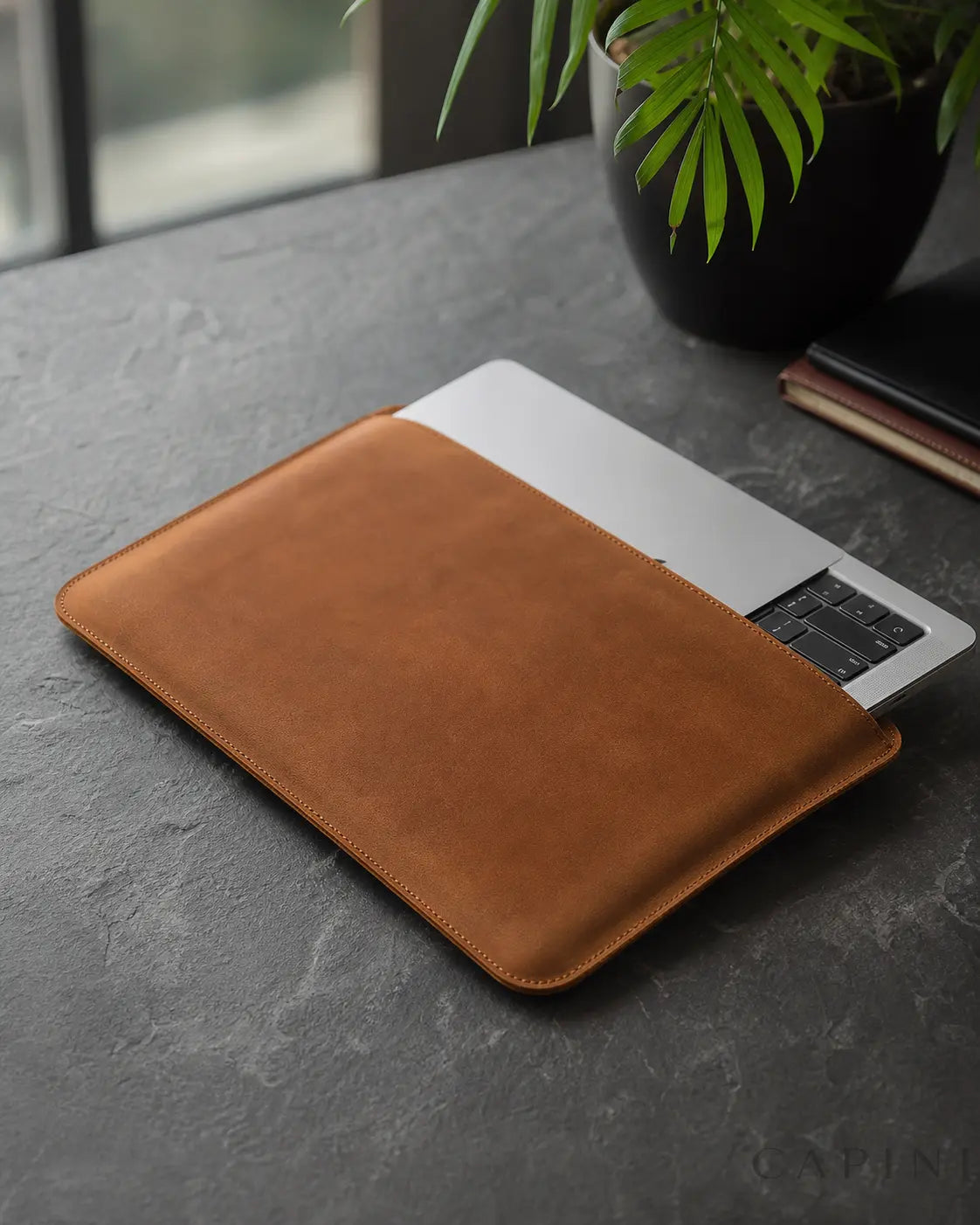 Pavia Cowhide MacBook Sleeve in cognac leather with a laptop being inserted