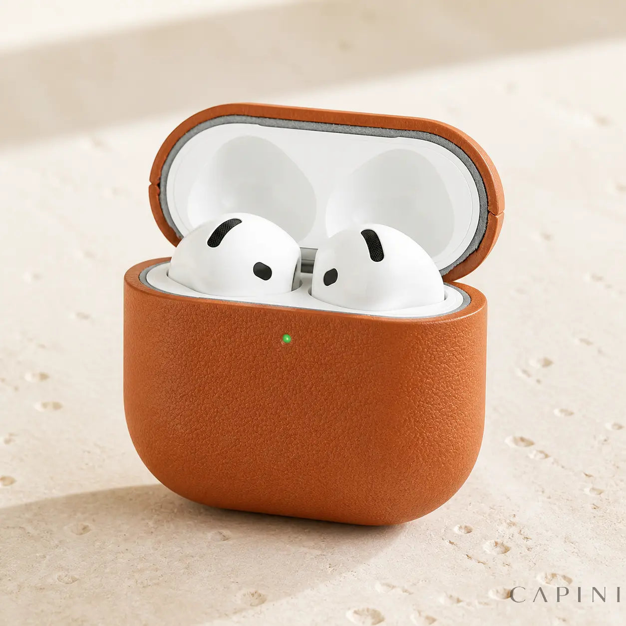 Pesaro Fine Grain cognac leather case open with AirPods 4