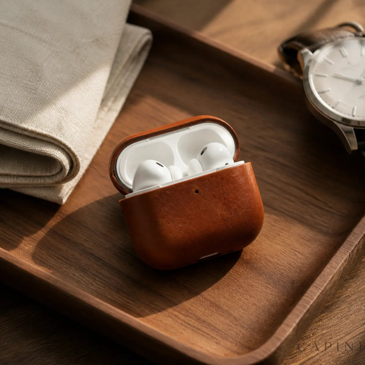 York Full-Grain Sundown leather case open with AirPods Pro 3