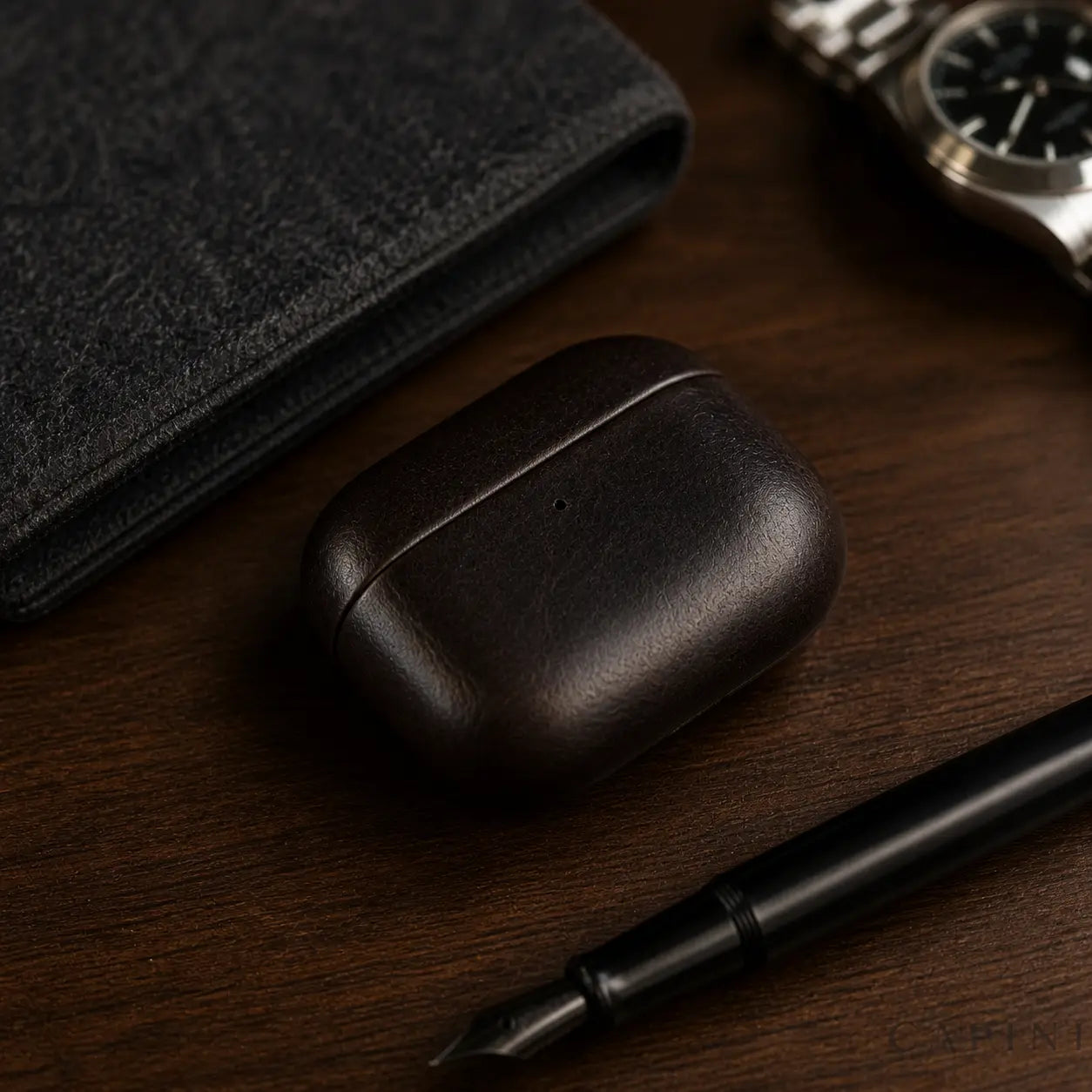 York Full-Grain Ebony leather AirPods Pro 3 case on a walnut desk