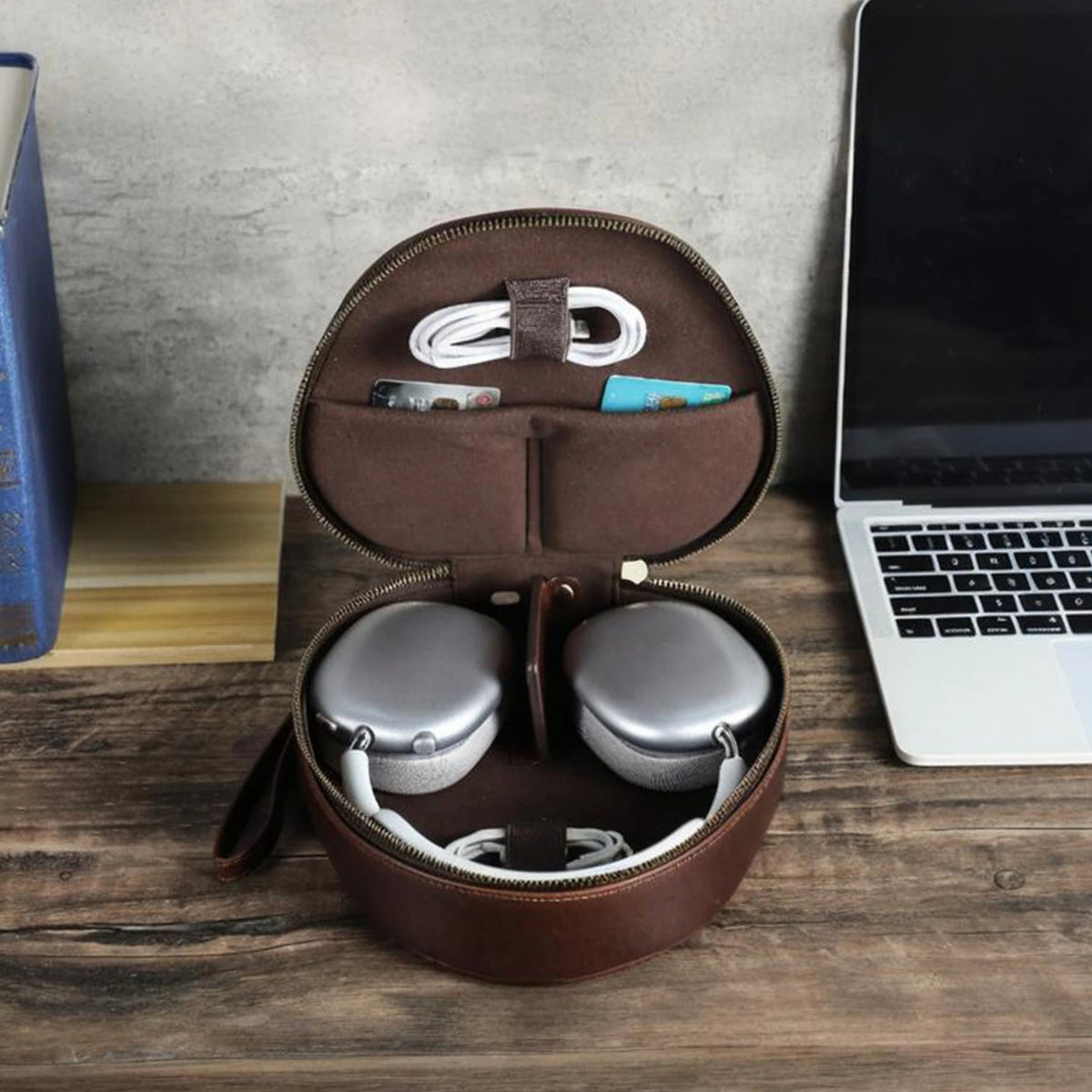 Sanremo case open on a desk with AirPods Max, cable and cards inside