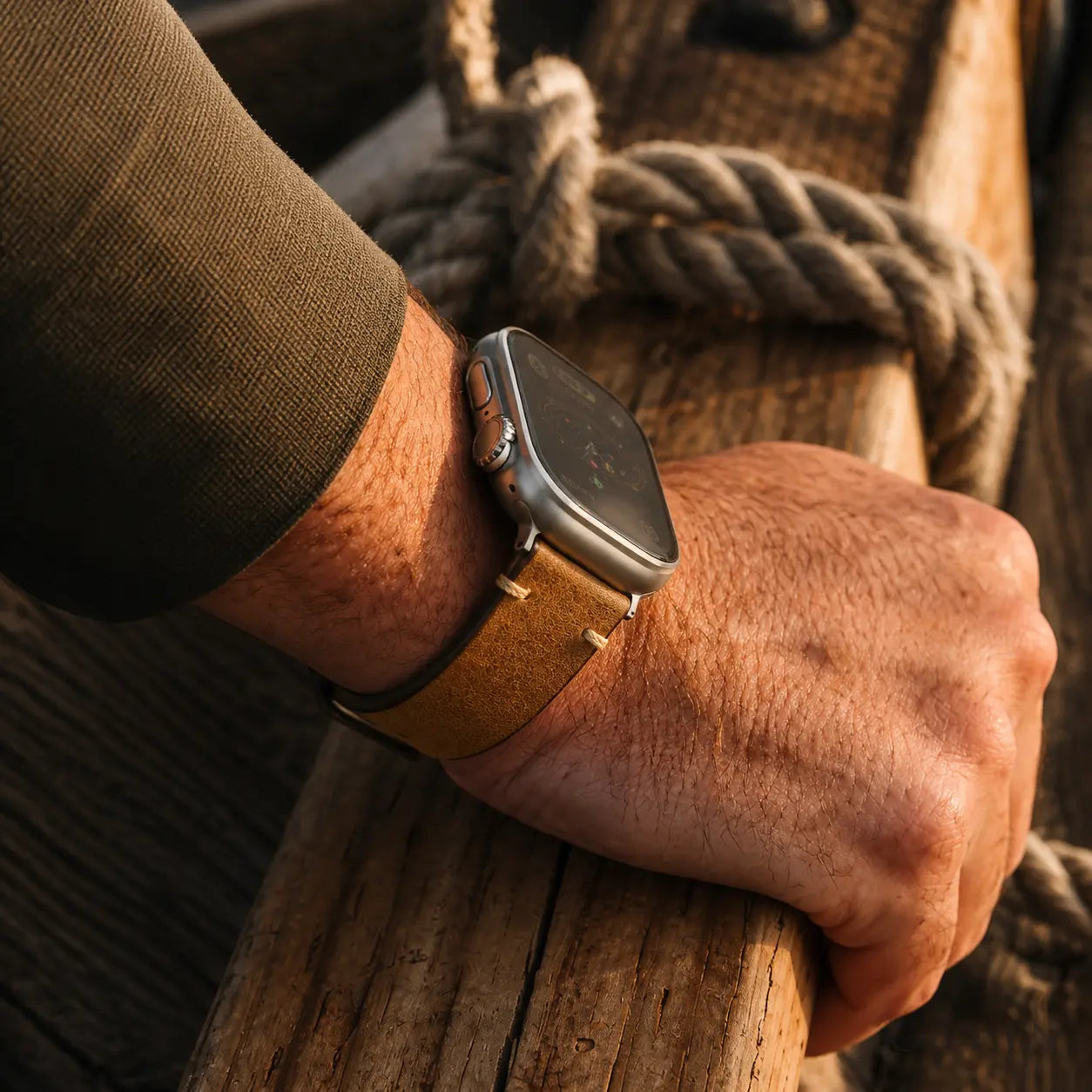 Brown Trieste oil-wax Apple Watch strap with silver hardware worn on the wrist