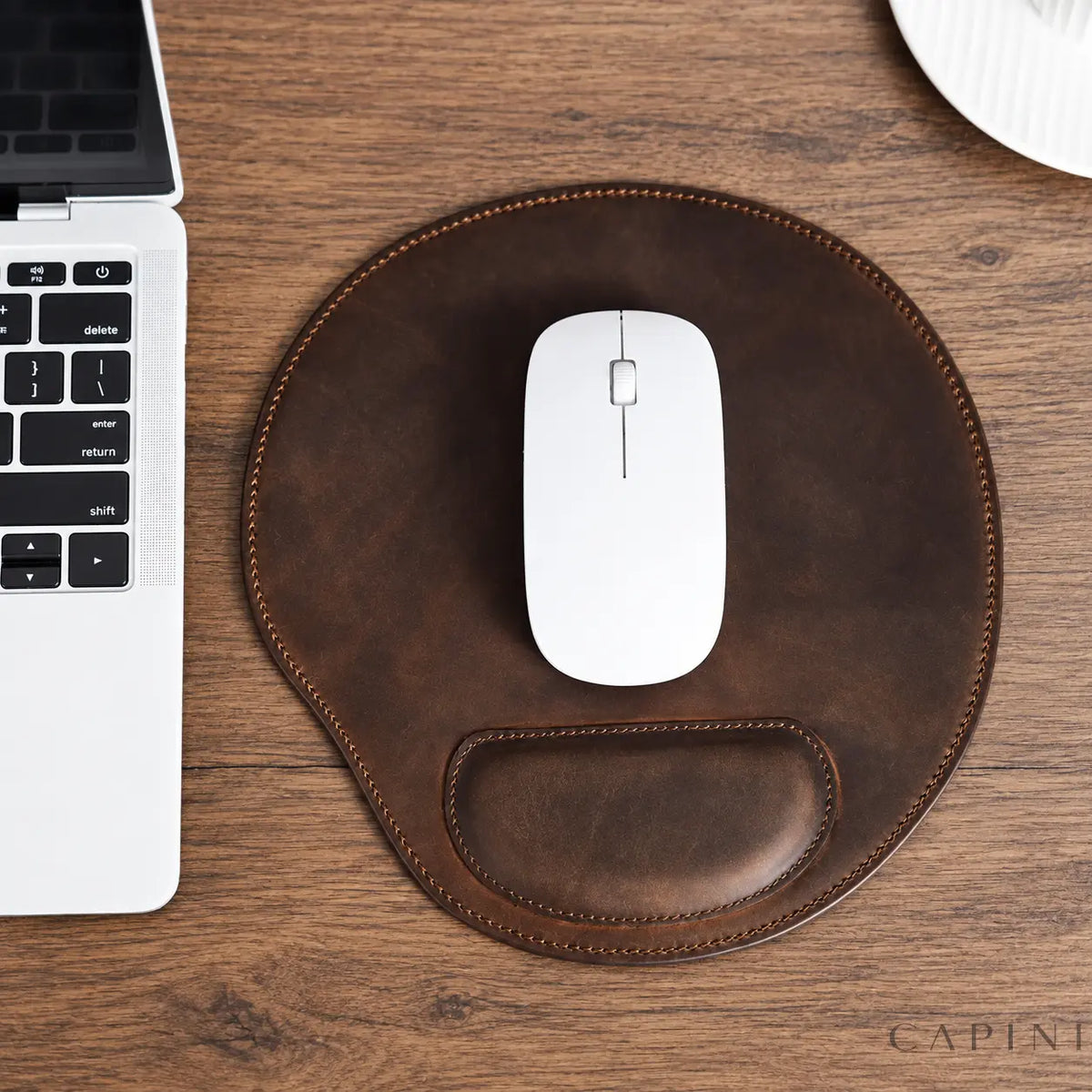 Urbino Crazy Horse brown leather mouse pad with white mouse on a wooden desk