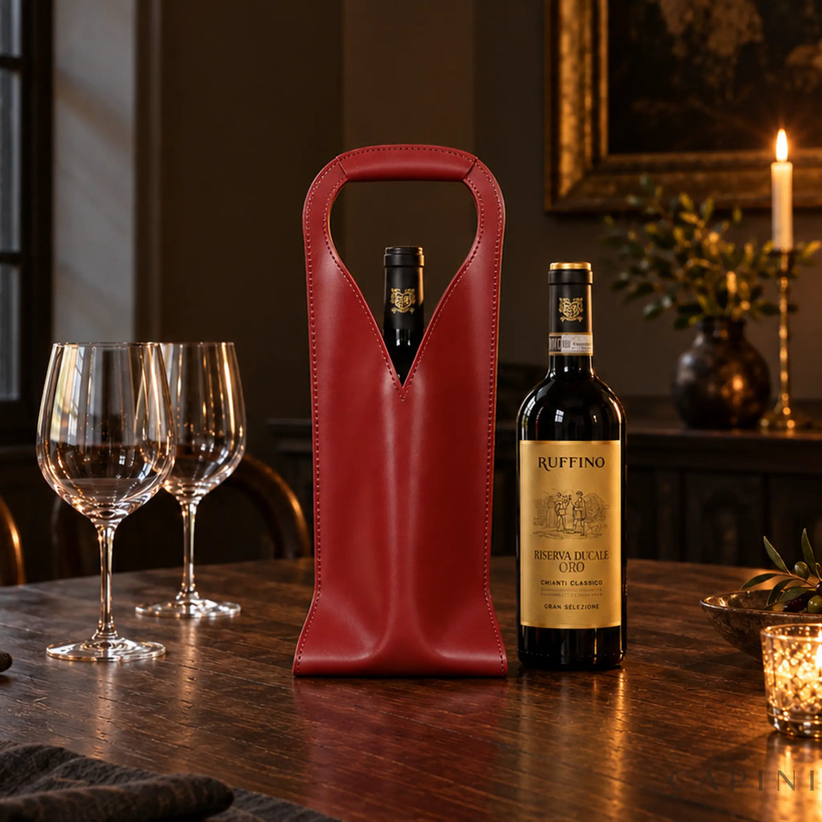Burgundy Cormons Loop Handle carrier beside a Ruffino Riserva Ducale Oro wine bottle on a walnut dinner table