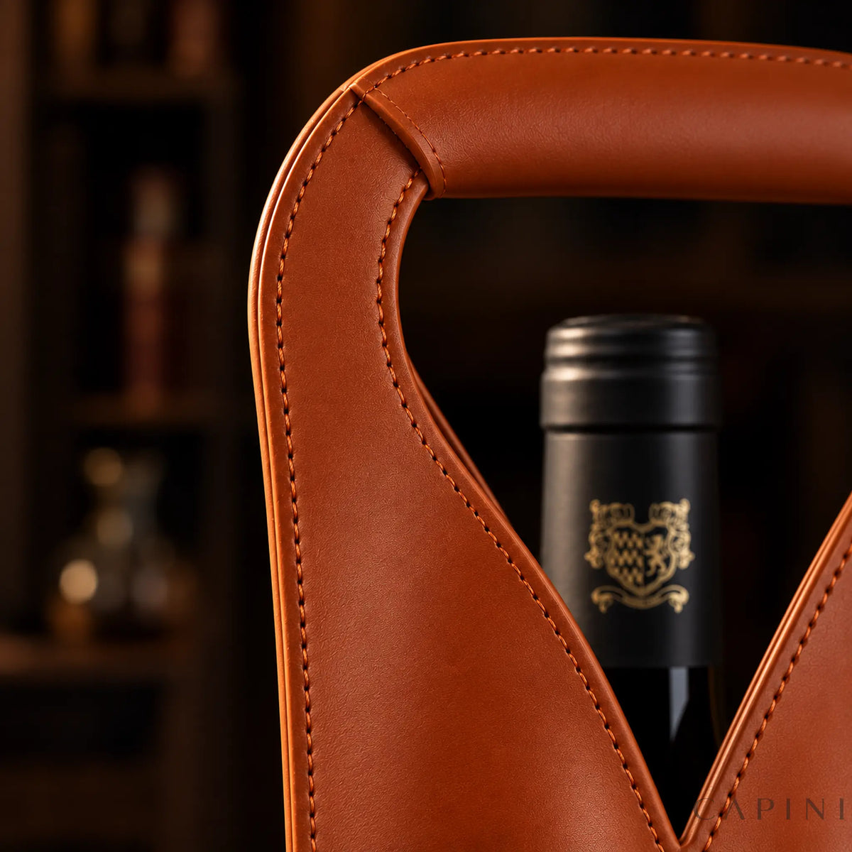 Close detail of the Cognac Cormons integrated handle overlap, smooth PU finish and tonal stitching