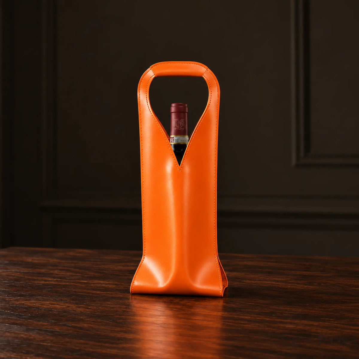 Cormons Loop Handle wine carrier in Orange on dark walnut