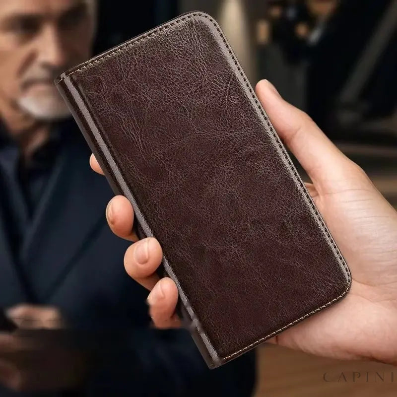 A man holding the closed Genova leather flip case in Mocha Brown