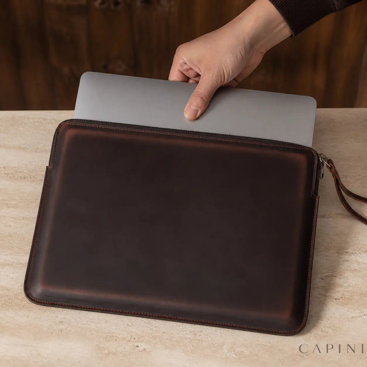 Silver MacBook being inserted into the Spoleto Espresso sleeve