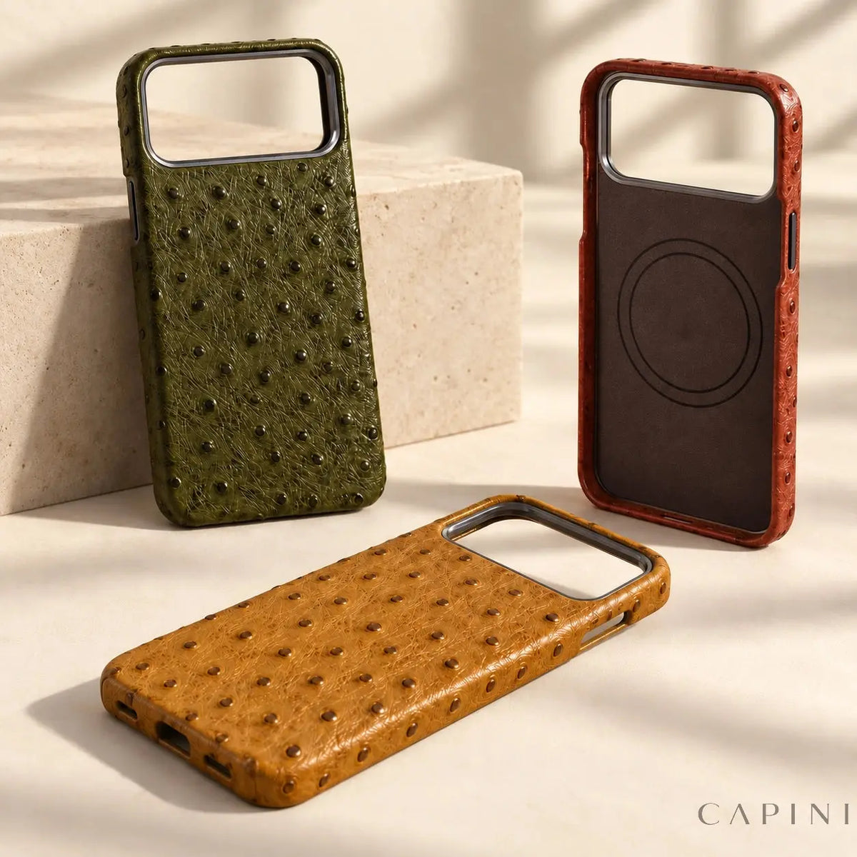 Empty Olive, Amber and Terracotta Deruta cases together in a clean studio composition; illustrative product photograph.