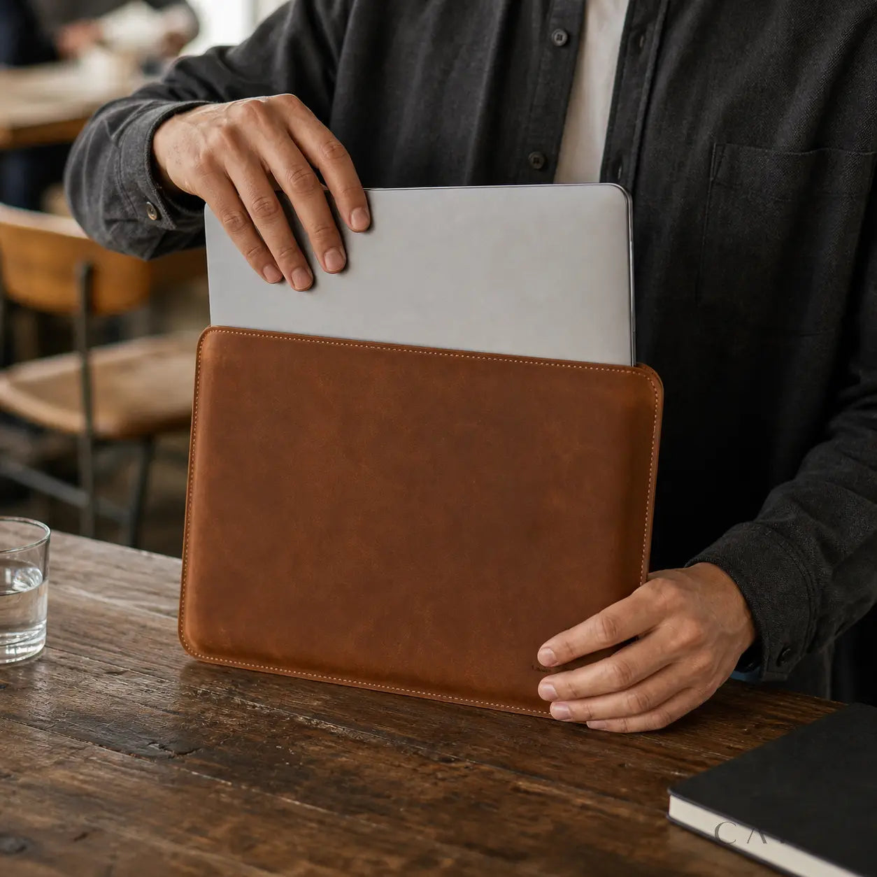 Ivrea Cognac leather MacBook sleeve with laptop partially inserted