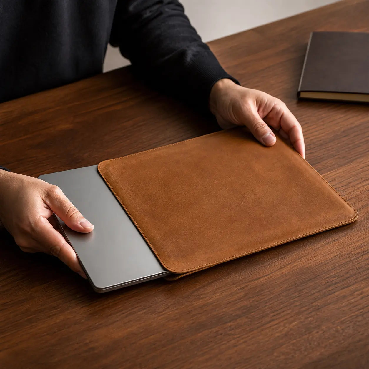 Pavia Cowhide MacBook Sleeve in cognac leather with a MacBook being inserted