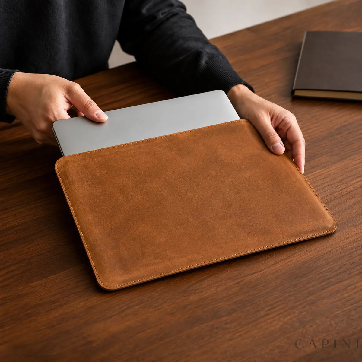 Closed silver laptop sliding through Pavia top long opening on walnut desk