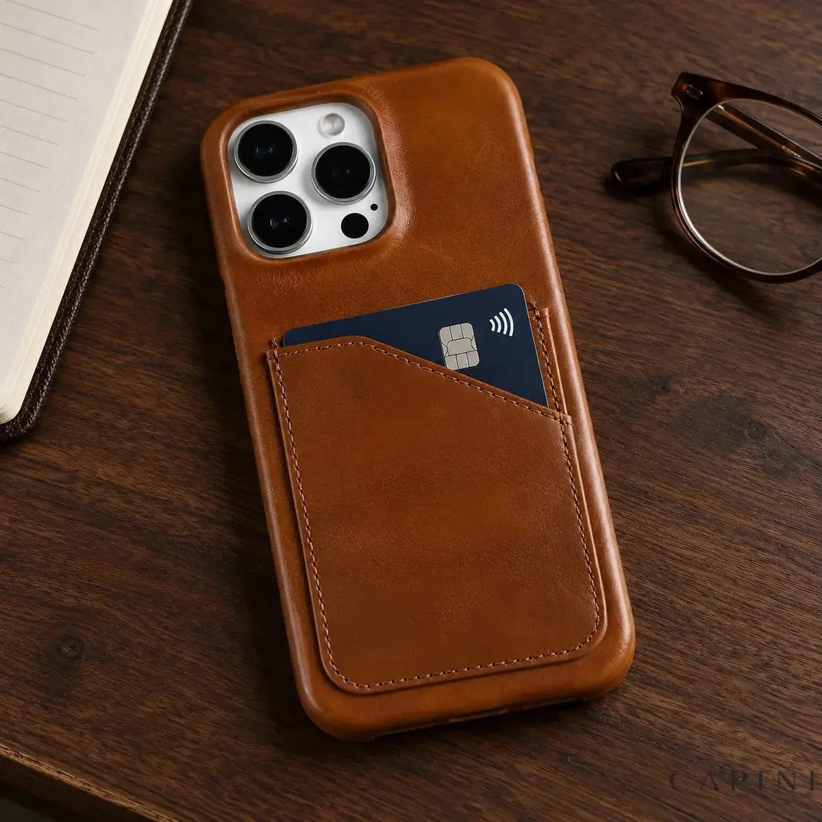 Treviso Cognac leather card-pocket case on a walnut desk